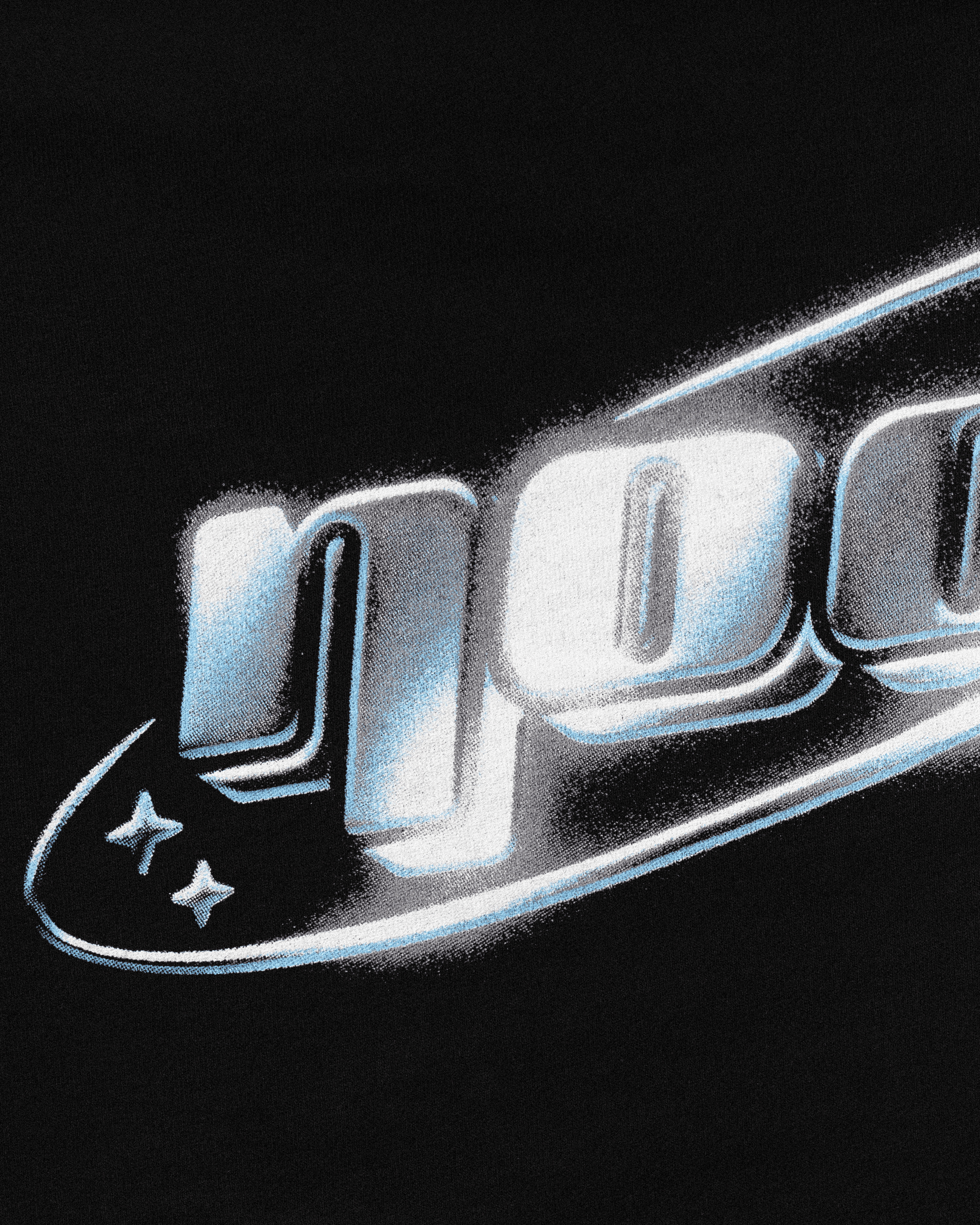Close up shot showing the high quality detail of the NOOB Chromatic logo printed on the back of a black, slight oversized, relaxed fit t-shirt.