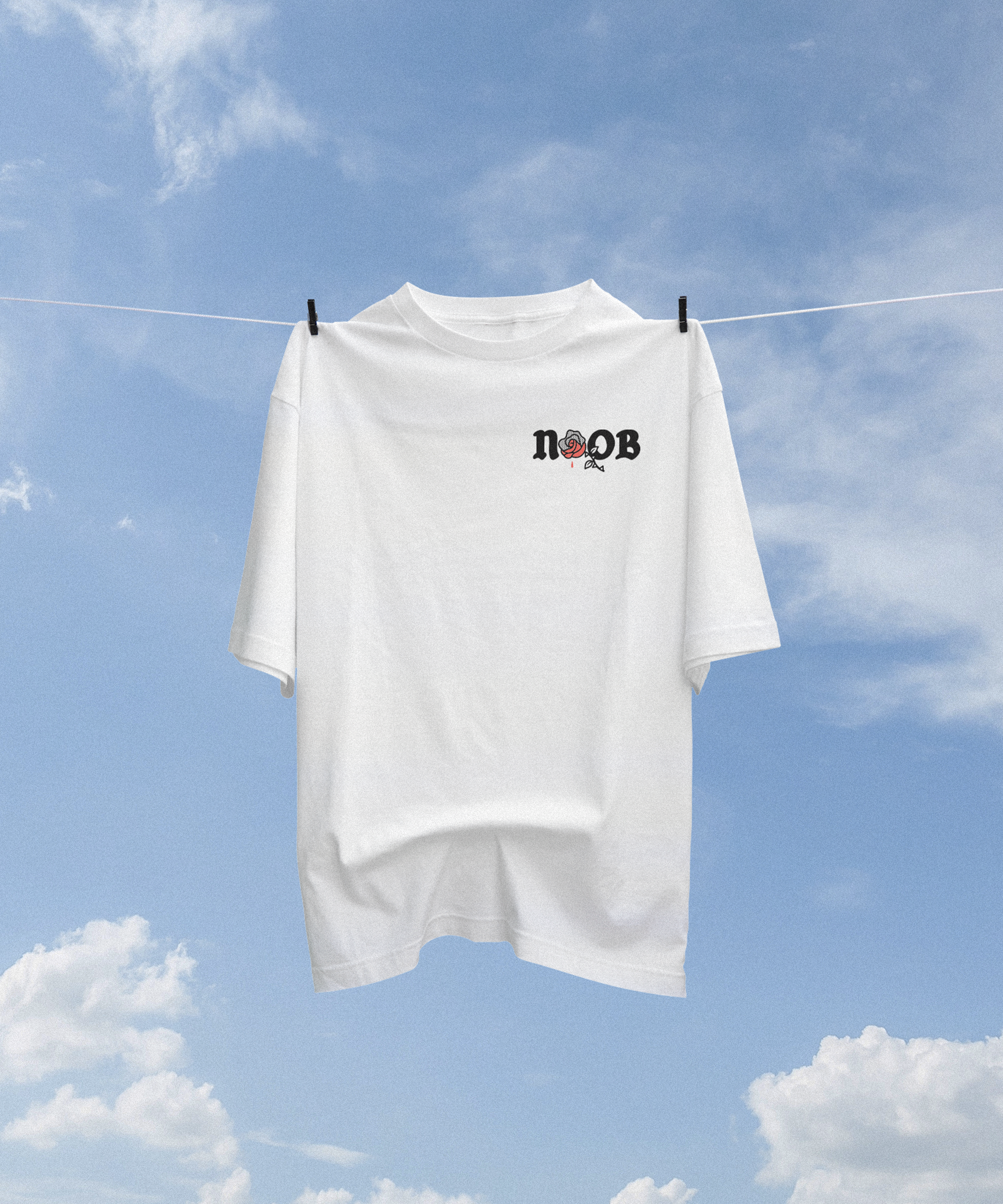 NOOB Obsidian white t-shirt floating in a blue sky